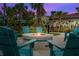 Outdoor fire pit surrounded by Adirondack chairs, perfect for gatherings with palm trees and outdoor seating at 4814 Cayview Ave # 407, Orlando, FL 32819