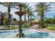 Beautiful fountain surrounded by lush greenery and palm trees in a resort setting at 4814 Cayview Ave # 407, Orlando, FL 32819