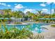 Resort-style community pool with bright blue umbrellas and well-maintained landscaping, perfect for residents to enjoy at 4814 Cayview Ave # 407, Orlando, FL 32819