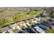 Expansive aerial view of residences bordering an attractive golf course and green spaces at 5025 St Andrews Arc, Leesburg, FL 34748