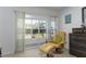 Relaxing bedroom corner with a comfortable chair, ottoman, and slider door access to the screened lanai at 5025 St Andrews Arc, Leesburg, FL 34748