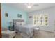 Cozy bedroom featuring a tufted headboard, calming blue accent wall, and natural light from shuttered windows at 5025 St Andrews Arc, Leesburg, FL 34748