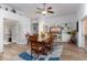 Bright dining room featuring wood floors, a ceiling fan, and natural light from sliding doors at 5025 St Andrews Arc, Leesburg, FL 34748