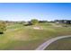 A beautiful aerial view of a lush golf course with a sand trap at 5025 St Andrews Arc, Leesburg, FL 34748