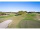 Aerial shot of the manicured golf course featuring mature trees and sand traps at 5025 St Andrews Arc, Leesburg, FL 34748