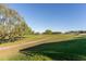 Picturesque view of the lush green golf course with blue skies at 5025 St Andrews Arc, Leesburg, FL 34748