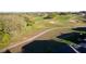 Scenic aerial view of a winding golf cart path through green fairways at 5025 St Andrews Arc, Leesburg, FL 34748