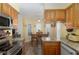 This bright kitchen displays modern appliances, granite countertops, and a dining area nearby at 5025 St Andrews Arc, Leesburg, FL 34748