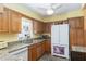 Functional kitchen featuring wood cabinets, granite countertops, and modern appliances at 5025 St Andrews Arc, Leesburg, FL 34748