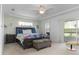 Spacious main bedroom with a tray ceiling, slider to lanai, and an en-suite bathroom at 5025 St Andrews Arc, Leesburg, FL 34748