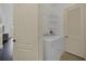 A practical laundry area equipped with a washer, dryer, and shelving at 506 Mirasol Cir # 202, Celebration, FL 34747