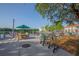 Outdoor seating area with wooden table and chairs, benches and scooters near a beautiful lake at 506 Mirasol Cir # 202, Celebration, FL 34747