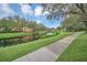 Serene community pond surrounded by lush green lawns, walking path and mature landscaping at 506 Mirasol Cir # 202, Celebration, FL 34747