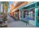 Charming storefronts with outdoor seating along a vibrant, palm-lined street in a retail district at 506 Mirasol Cir # 202, Celebration, FL 34747