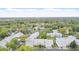 Aerial view of the townhome community showcasing landscaping, pool, and tennis courts at 5336 White Cliff Ln # 6, Orlando, FL 32812