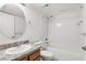 Bright bathroom featuring a single sink vanity, oval mirror, and shower-tub combination at 5336 White Cliff Ln # 6, Orlando, FL 32812