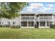 Exterior view of a two-story townhome with balconies and a lush green lawn at 5336 White Cliff Ln # 6, Orlando, FL 32812