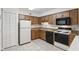 Traditional kitchen featuring oak cabinets, black appliances, and neutral countertops at 5336 White Cliff Ln # 6, Orlando, FL 32812