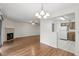 Open-concept living room with wood floors flowing into the kitchen and fireplace at 5336 White Cliff Ln # 6, Orlando, FL 32812