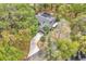 Stunning aerial view of home featuring lush landscaping, solar panels, and inviting driveway at 5374 Crooked Oak Cir, St Cloud, FL 34771