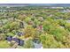 Aerial view showcases a home surrounded by lush trees and a nearby canal at 5374 Crooked Oak Cir, St Cloud, FL 34771