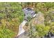 Overhead aerial view of a home with a long driveway, solar panels, and mature trees providing shade and privacy at 5374 Crooked Oak Cir, St Cloud, FL 34771