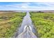 Aerial view of a boat driving down a river leading to a expansive lake, surrounded by green landscape at 5374 Crooked Oak Cir, St Cloud, FL 34771