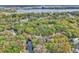 Aerial view of home near Ajay Lake, highlighting mature trees, the roof and panels at 5374 Crooked Oak Cir, St Cloud, FL 34771