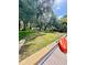 Spacious backyard featuring mature trees, lush grass, and a waterfront canal at 5374 Crooked Oak Cir, St Cloud, FL 34771