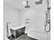 Modern bathroom with a sleek black soaking tub, rain shower head, herringbone tile, and a bench at 5374 Crooked Oak Cir, St Cloud, FL 34771