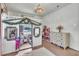 Bright bedroom featuring a lofted playhouse-style bed and hardwood floors at 5374 Crooked Oak Cir, St Cloud, FL 34771