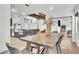 Dining area features a rustic table, chairs, and bench with an open view to the kitchen at 5374 Crooked Oak Cir, St Cloud, FL 34771