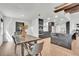 Dining room features a rustic table with a vase centerpiece, wooden beams, and modern light fixtures at 5374 Crooked Oak Cir, St Cloud, FL 34771