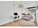 Bright home office with a modern chandelier and a view into the living room at 5374 Crooked Oak Cir, St Cloud, FL 34771