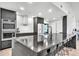 Modern kitchen features sleek black cabinets, stainless steel appliances, and large island at 5374 Crooked Oak Cir, St Cloud, FL 34771