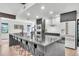 Open kitchen boasts a large island with seating, modern appliances, and stylish design at 5374 Crooked Oak Cir, St Cloud, FL 34771