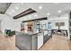 Spacious kitchen features an island with a farmhouse sink and stone accents and wooden beam ceiling at 5374 Crooked Oak Cir, St Cloud, FL 34771