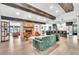 Bright living room with wood floors, stone fireplace, exposed beams, and modern furnishings at 5374 Crooked Oak Cir, St Cloud, FL 34771