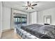 The Main bedroom with a ceiling fan and screened patio access at 5374 Crooked Oak Cir, St Cloud, FL 34771