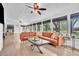 Spacious sunroom filled with natural light, featuring comfortable seating and modern ceiling fan at 5374 Crooked Oak Cir, St Cloud, FL 34771