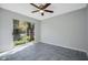 Light-filled bedroom with tile flooring and access to screened lanai at 6050 Scotchwood Gln # Ge, Orlando, FL 32822