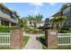 Inviting courtyard with lush landscaping, mature palm trees, and a paved walkway at 6050 Scotchwood Gln # Ge, Orlando, FL 32822