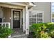 Inviting entrance with decorative door and attractive landscaping at 6050 Scotchwood Gln # Ge, Orlando, FL 32822