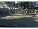 View of a backyard with a wooden fence and mature trees at 6321 Redwood Oaks Dr, Orlando, FL 32818