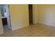 Bedroom with tile floor, yellow walls, view of a bathroom, and a closet at 6321 Redwood Oaks Dr, Orlando, FL 32818