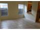 Cozy dining area with tile flooring, natural light, and a view of the kitchen through an open bar at 6321 Redwood Oaks Dr, Orlando, FL 32818