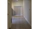 Bright hallway featuring tile flooring and natural light from the sliding glass doors at 6321 Redwood Oaks Dr, Orlando, FL 32818