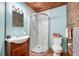 Charming bathroom featuring stylish vanity, updated shower, and decorative brick accents at 6424 Jenny Dr, Lake Wales, FL 33898