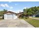 Charming single-story home featuring an attached two-car garage and a well-maintained front yard with mature landscaping at 6424 Jenny Dr, Lake Wales, FL 33898