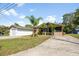 Exterior view of the home, featuring the driveway, garage, and landscaping at 6424 Jenny Dr, Lake Wales, FL 33898